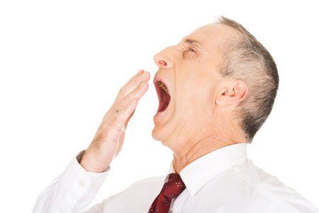 Exhausted and sleepy businessman yawning.の写真素材
