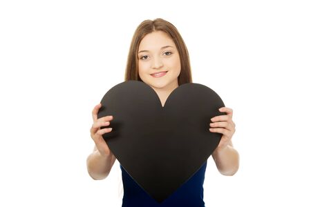 Beautiful teenage woman holding paper heart.の写真素材