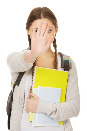 Teenager girl with school backpack make stop gesture.の写真素材