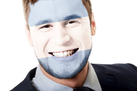 Happy man with Argentina flag painted on face.の写真素材