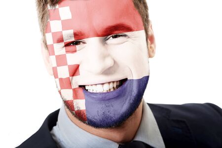 Happy man with Croatia flag painted on face.の写真素材