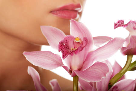 Young beautiful woman with pink flower.の写真素材