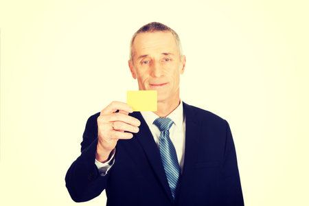 Businessman showing a yellow identity name card.の写真素材