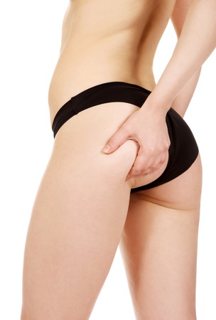 Young woman in panties touching her back.の写真素材