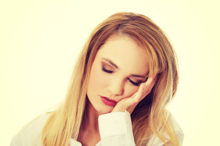 Young beautiful woman resting her head on hand.の写真素材