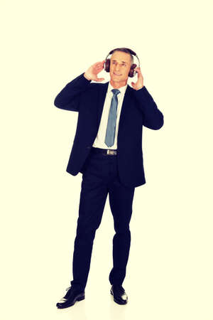 Full length businessman with big headphones.の写真素材