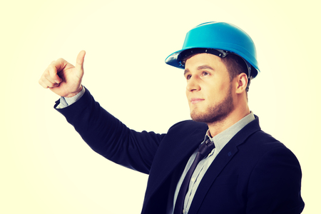 Happy handsome businessman in helmet showing ok sign.の写真素材