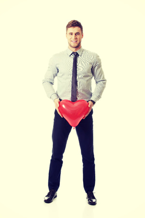 Young happy man with heart balloon.の写真素材