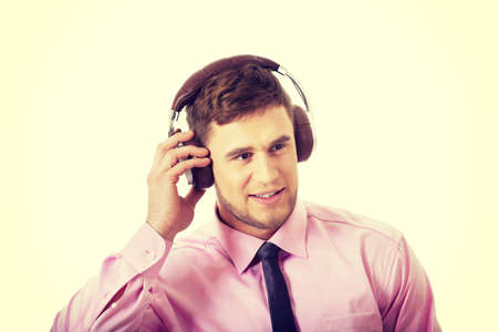 Young businessman listening to music wearing headphones.の写真素材