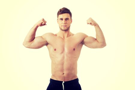 Young handsome athletic man showing his muscles.の写真素材