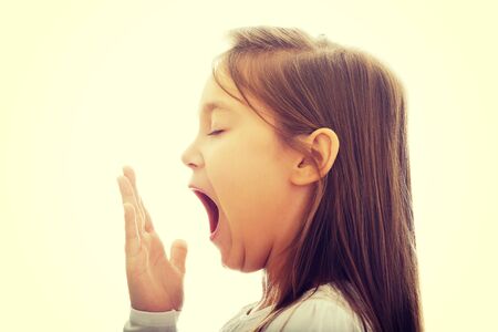 Pretty brunette young girl yawningの写真素材