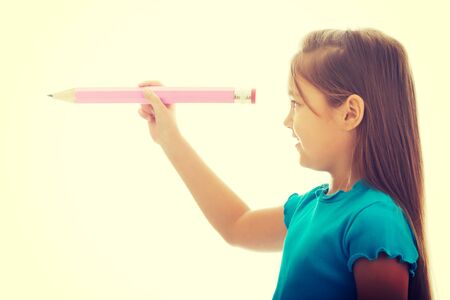 Little pretty girl with a pencilの写真素材