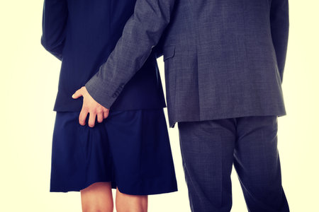 Young businessman holding hand on his beautiful partners assの写真素材