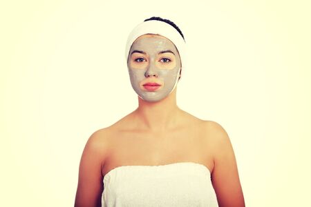 Relaxed woman with  a deep cleansing nourishing face mask applied to her face, beauty and skincare conceptの写真素材