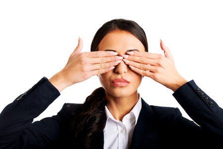 Young businesswoman covering eyes with hands.の写真素材