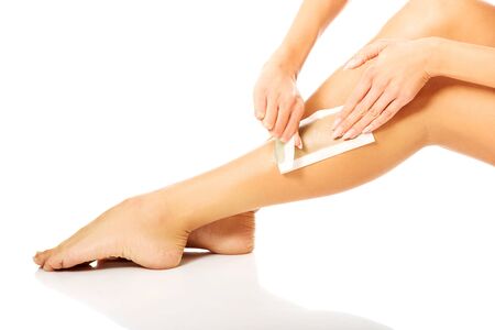 Spa woman waxing her legの写真素材