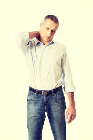 Fashionable mature man with neck pain.の写真素材
