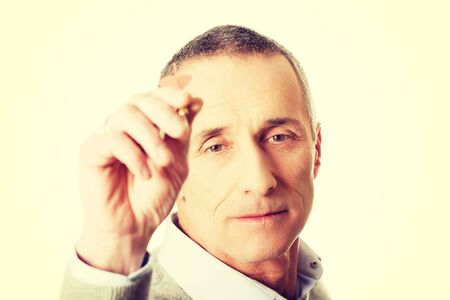 Mature man aiming by dart.の写真素材