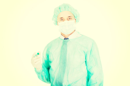 Mature male doctor holding a syringe.の写真素材