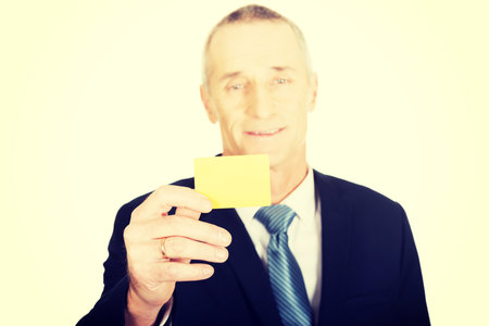 Businessman showing a yellow identity name card.の写真素材