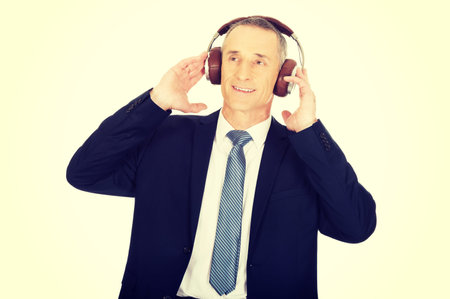 Mature businessman with big headphones.の写真素材