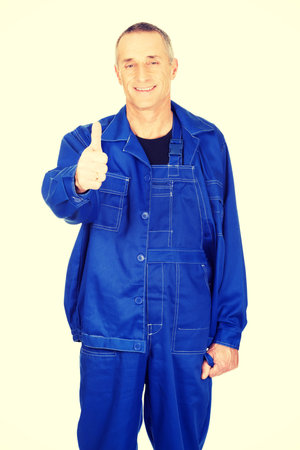 Mature repairman showing thumbs up.の写真素材