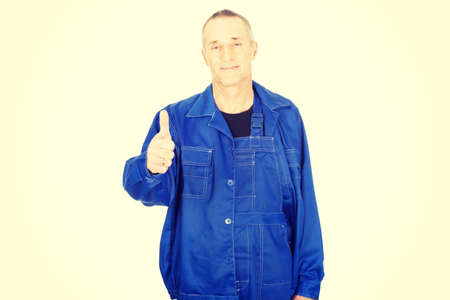 Mature repairman showing thumbs up.の写真素材