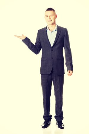 Young smiling businessman holding copyspace.の写真素材