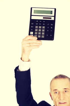 Businessman holding a calculator above his head.の写真素材