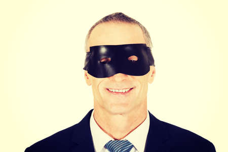 Serious mature businessman wearing eye maskの写真素材