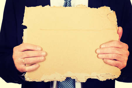 Male hand with a piece of cardboardの写真素材