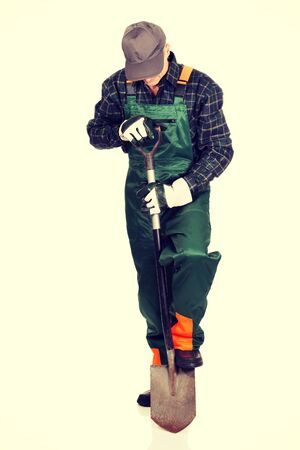 Smiling experienced gardener with a spadeの写真素材