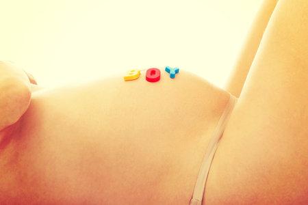 Belly of a young pregnant woman with boy letteringの写真素材