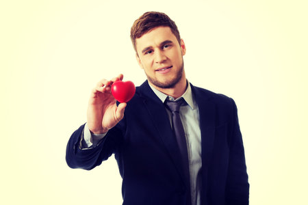 Handsome businessman with heart model.の写真素材