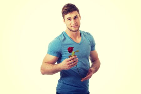 Young handsome man with red rose.の写真素材