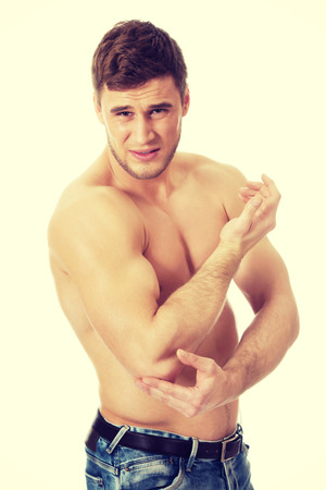 Handsome athletic man suffering from elbow pain.の写真素材