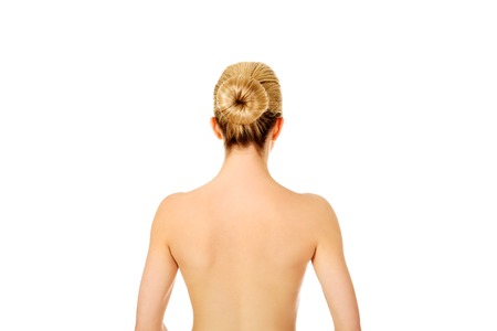 Back of young woman after bath or spa, isolated on white.の写真素材