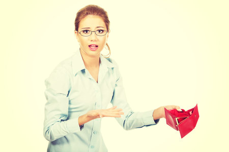Unhappy businesswoman holding empty purse.