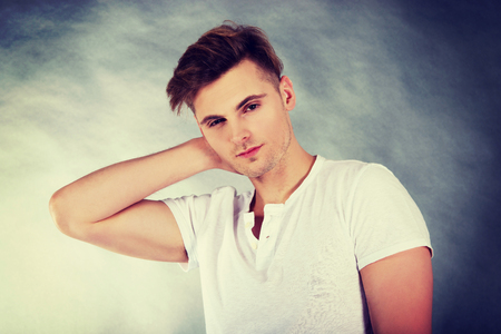 Young man suffering from neck pain.の写真素材