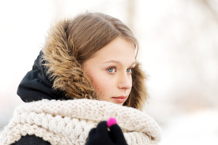 Teenage woman in winter clothes outdoorの写真素材