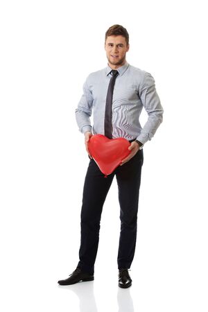 Young happy man with heart balloon.の写真素材