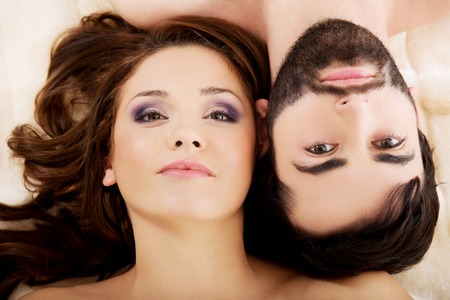 Relaxed loving young couple lying in bed.の写真素材