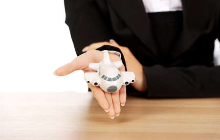 Businesswoman holding a toy airplane.の写真素材