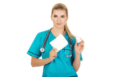 Female nurse holding gauze and hydrogen peroxide.の写真素材