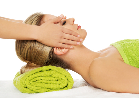 Young woman has face massage in spa.の写真素材