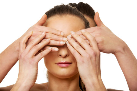 Spa woman covering friend's eyes.の写真素材
