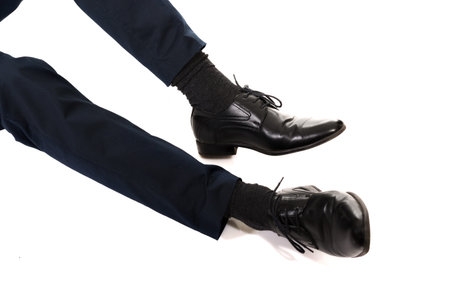 Close-up of businessman feet in black boots.