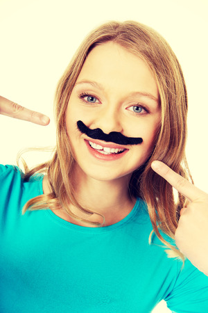 Happy teenage woman with a moustacheの写真素材
