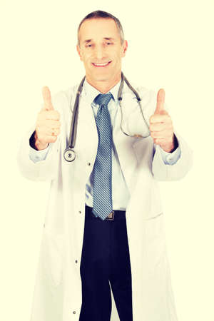 Confident mature male doctor with thumbs up.の写真素材