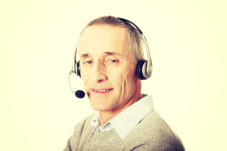 Call center mature man wearing a headset.の写真素材